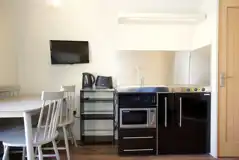 Superior pod kitchenette, dining table, and TV
