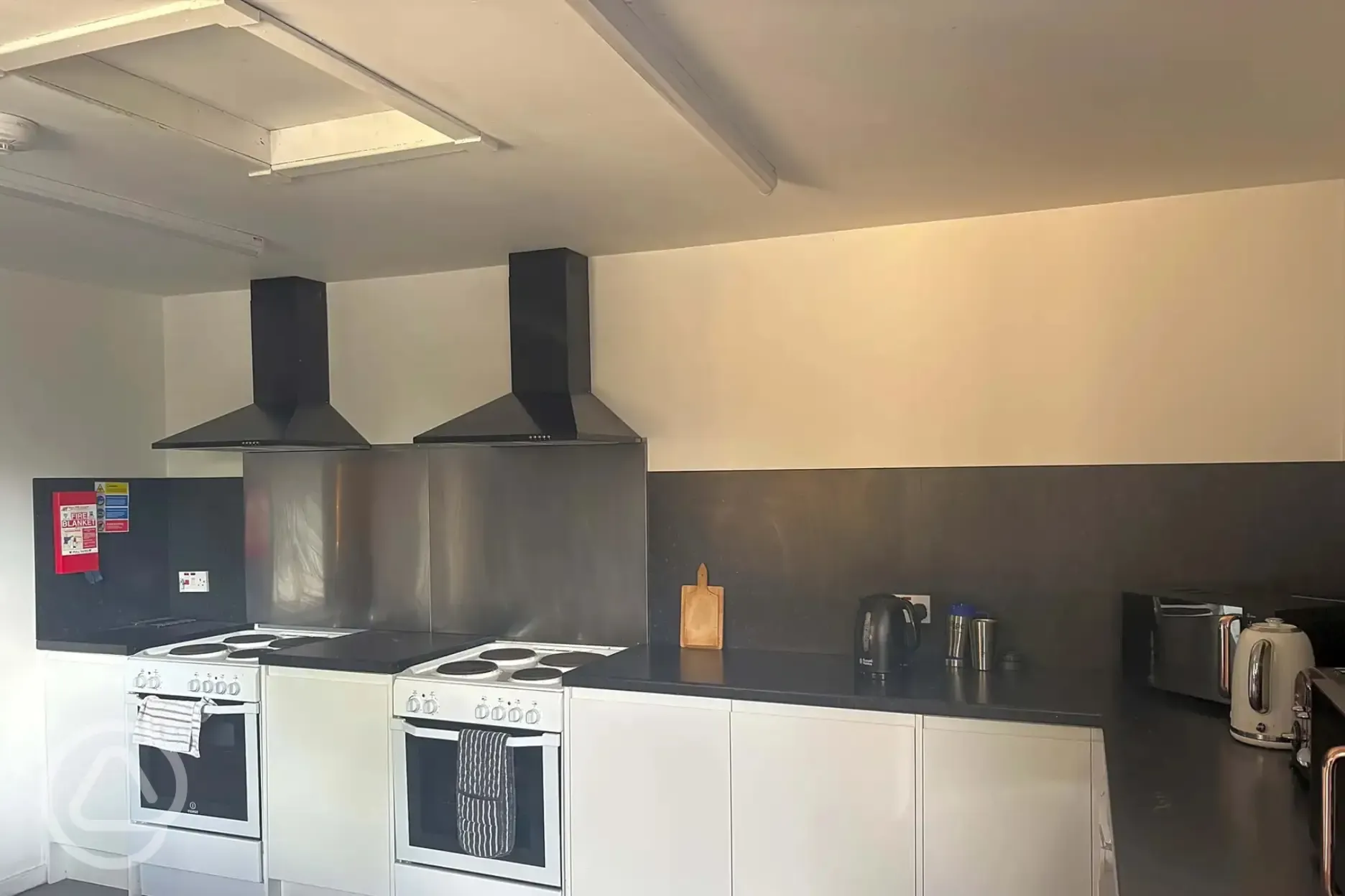 Communal kitchen with ovens, hobs, and cooking equipment