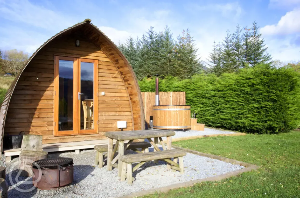 Premium ensuite glamping pod with private wood-fired hot tubs and picnic bench