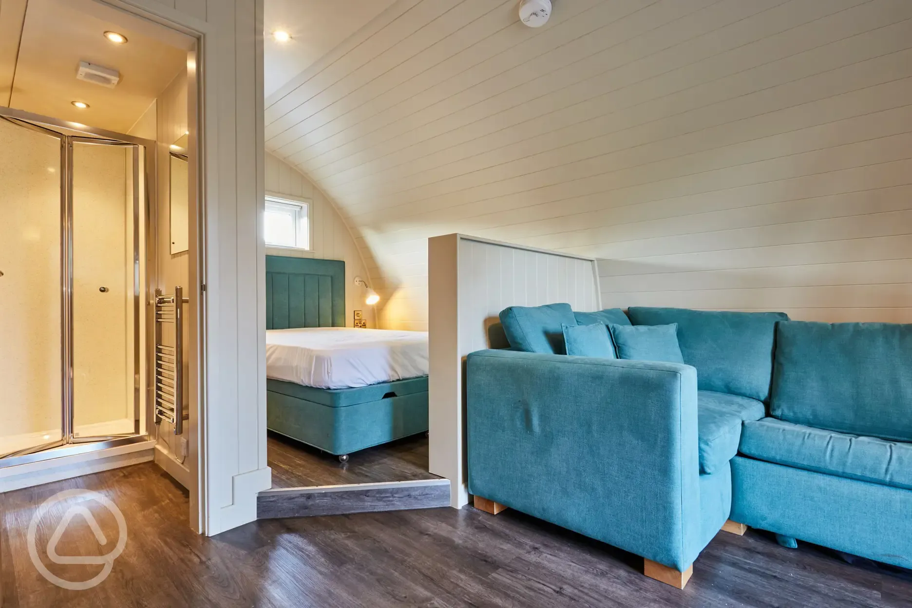 Superior ensuite glamping pod interior with double bed and sofa