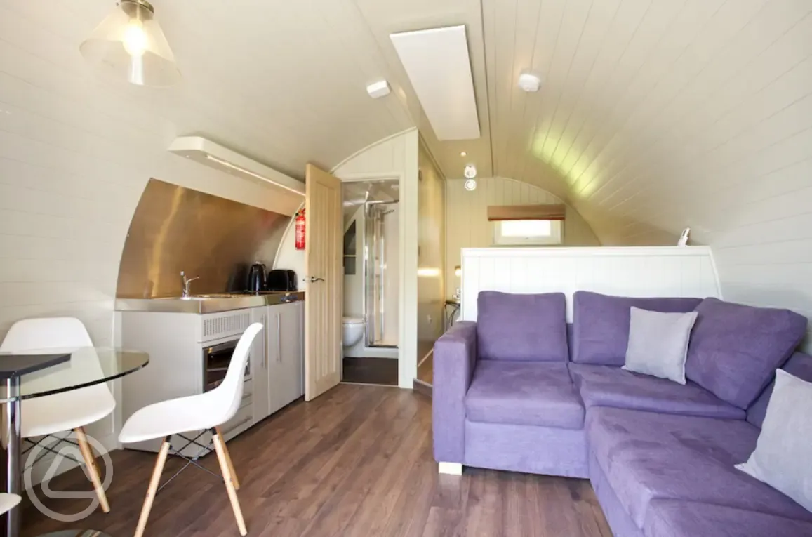 Kitchen and sofa in the superior ensuite glamping pod