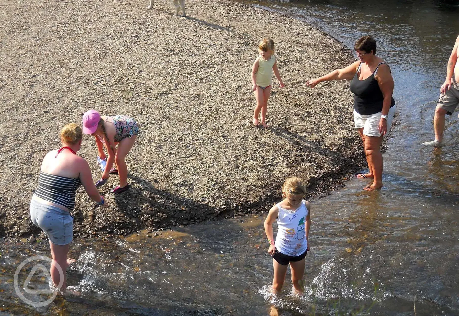 Children playing on the sandy river bank