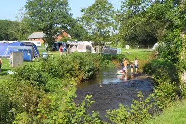 Grass pitches by the River Mole for paddling