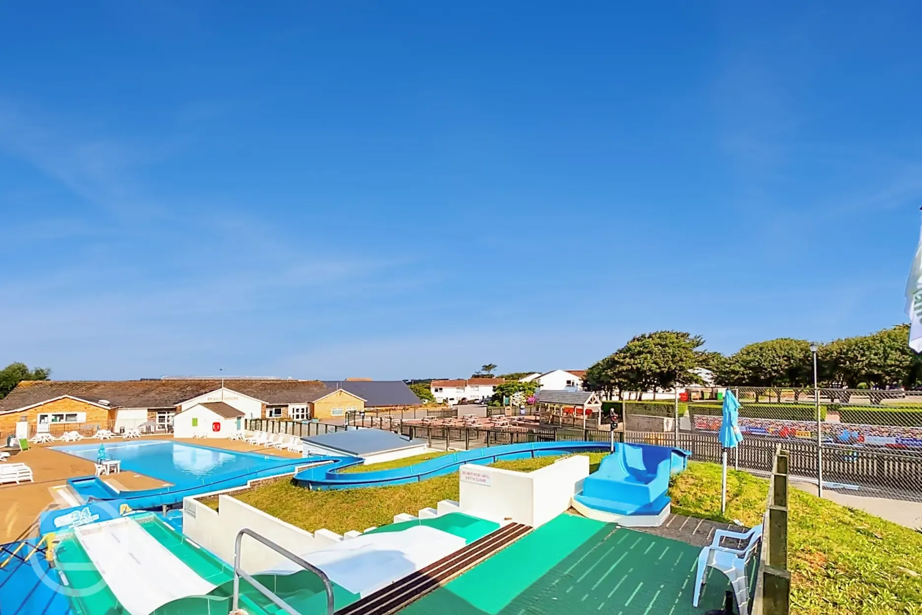 Heated outdoor swimming pool (open during summer) with slides and a splash pad