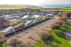 Aerial of the gravel touring pitches backed by hedges and trees