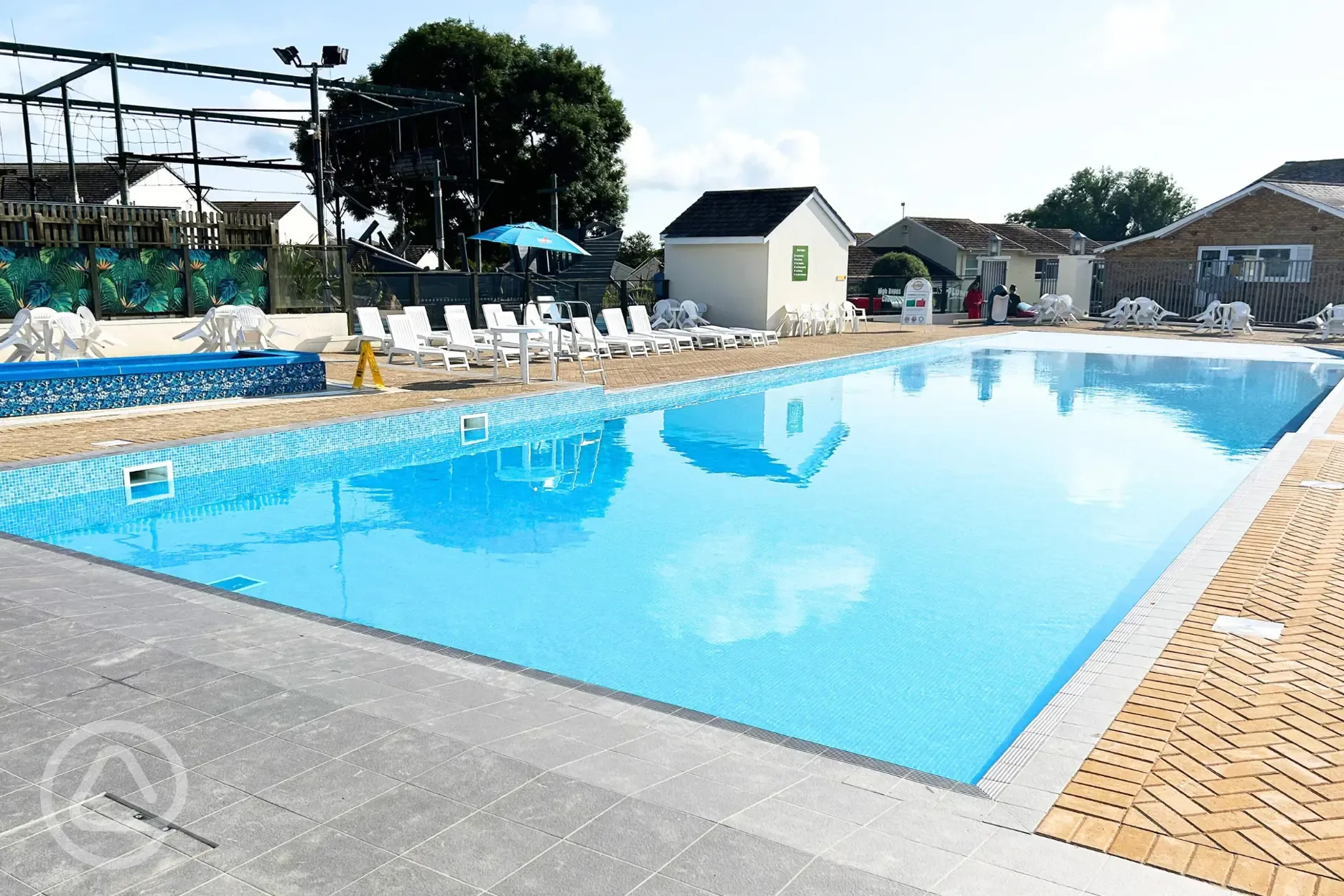 Heated outdoor swimming pool (open during summer) with slides and a splash pad