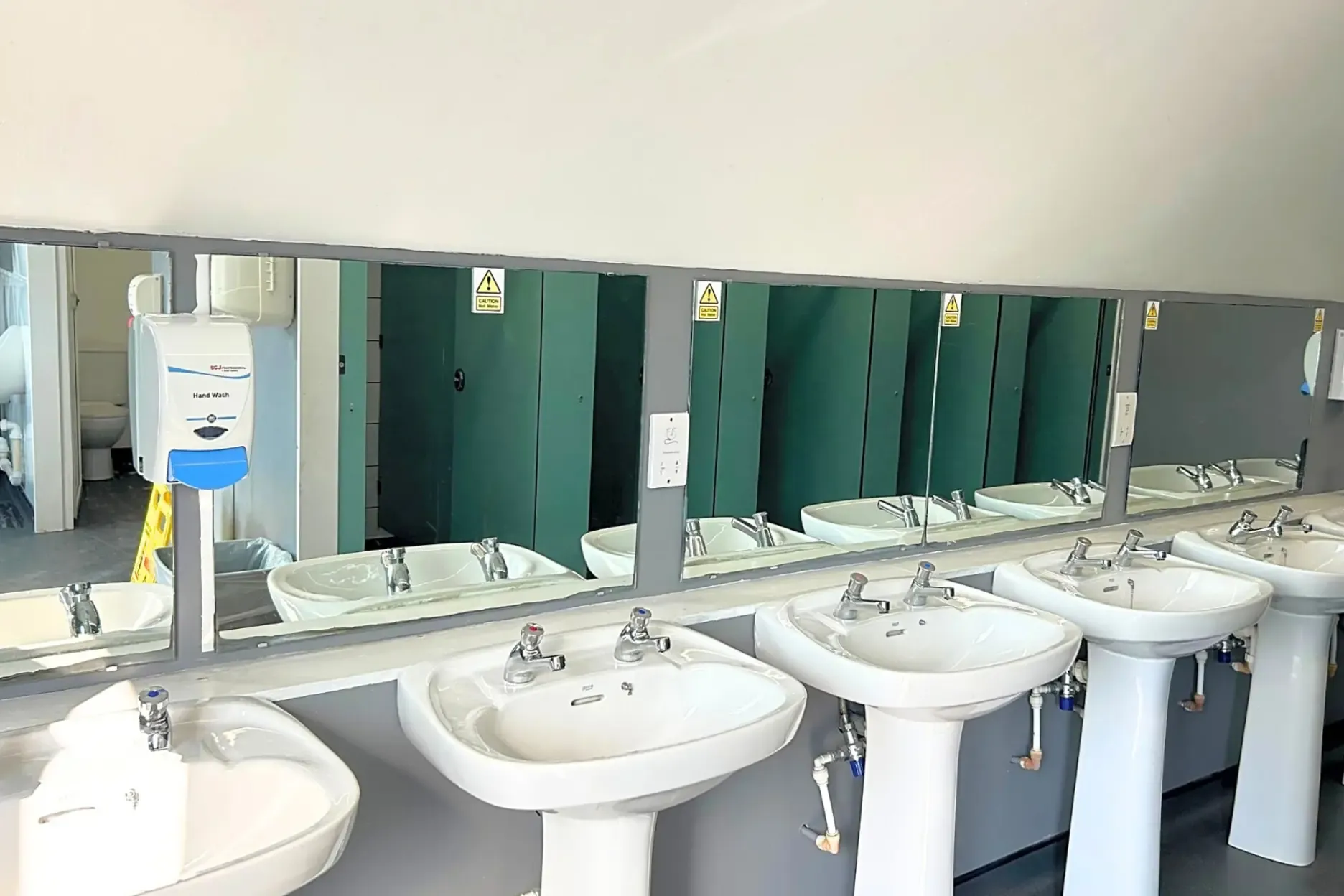 Hand basins in the bathrooms with shaving sockets