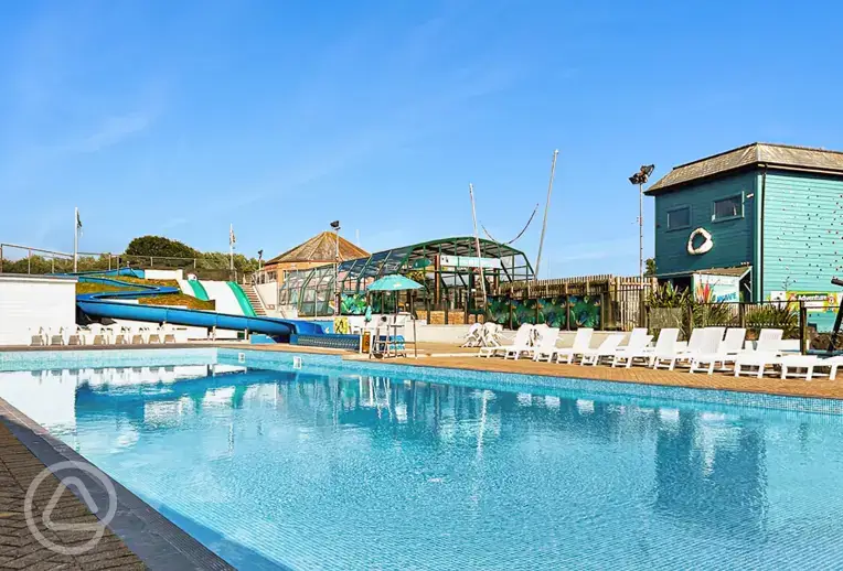 Heated outdoor swimming pool (open during summer) with slides and a splash pad