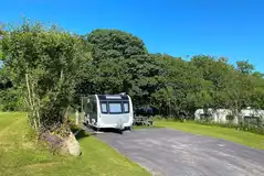 Fully serviced hardstanding pitches surrounded by trees