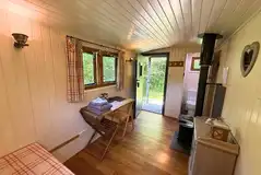 Shepherd's Hut wood burning stove, seating area and toilet