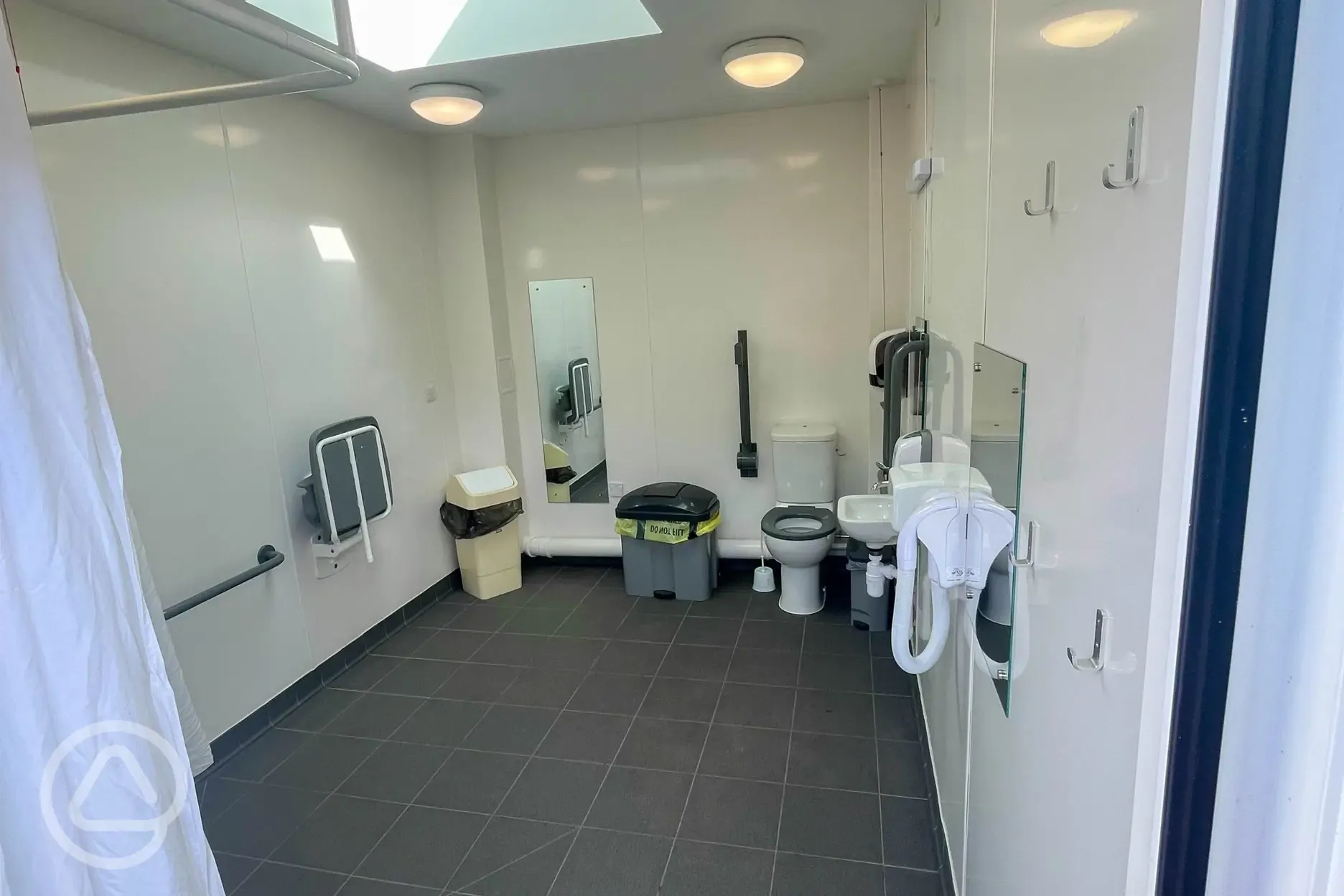 Accessible bathroom with grab rails, shower, and baby changing Accessible bathroom with grab rails, shower, and baby changing