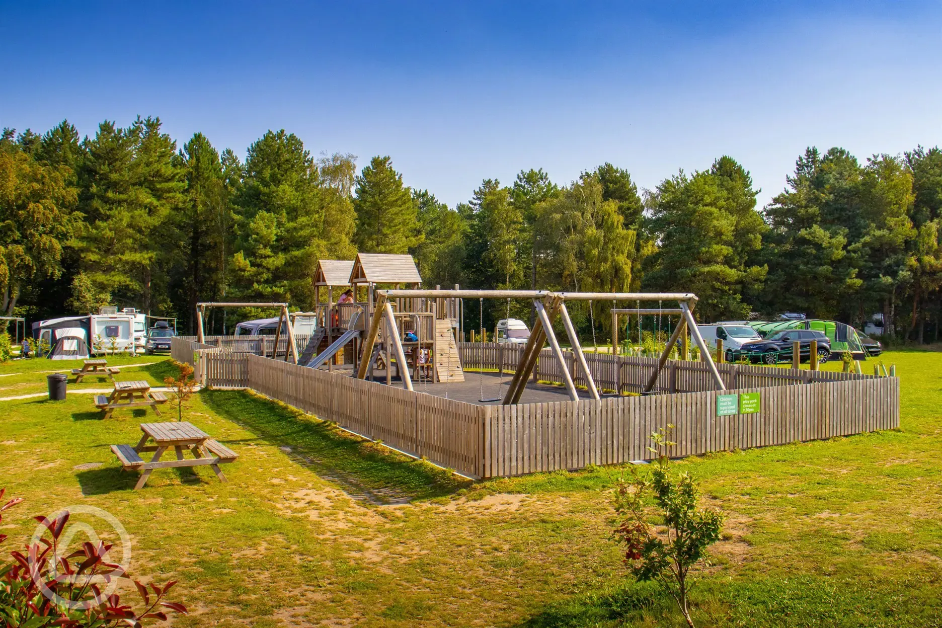Children's play area with swings, slides, and climbing frames Children's play area with swings, slides, and climbing frames