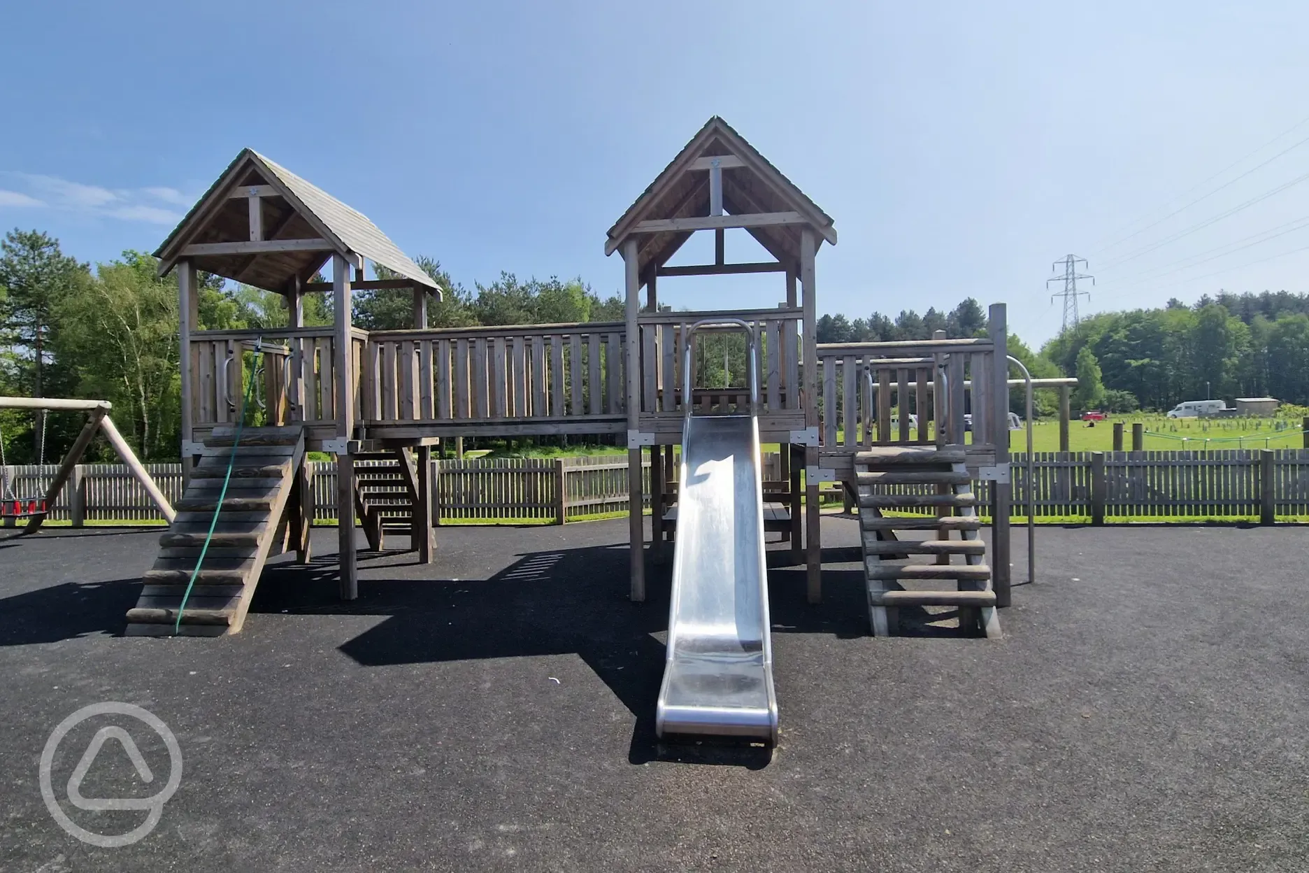 Children's play area with swings, slides, and climbing frames Children's play area with swings, slides, and climbing frames