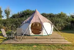 Lotus Belle Tent on a deck area with outdoor furniture