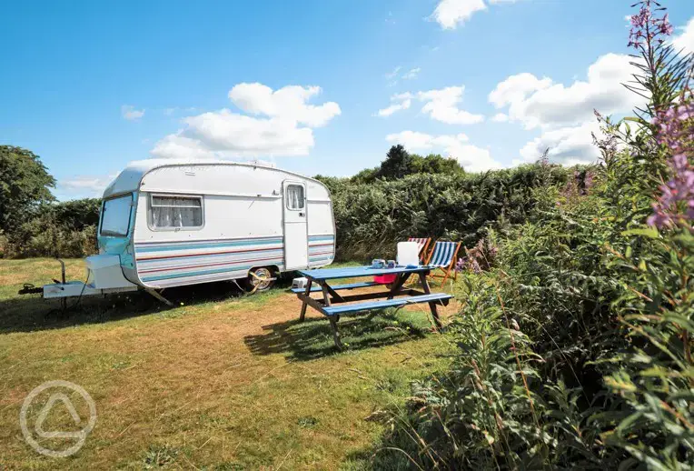 Dolly vintage caravan with outdoor furniture and deck chairs