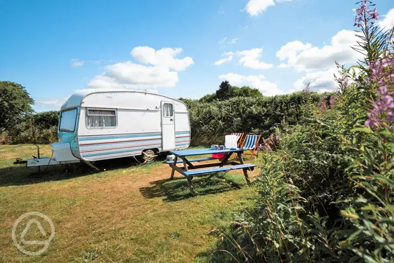 Dolly vintage caravan with outdoor furniture and deck chairs