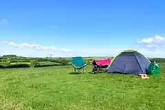 Non electric wild grass tent pitches, set away from the main campsite