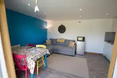 Glamping cabin living and kitchen area with a TV