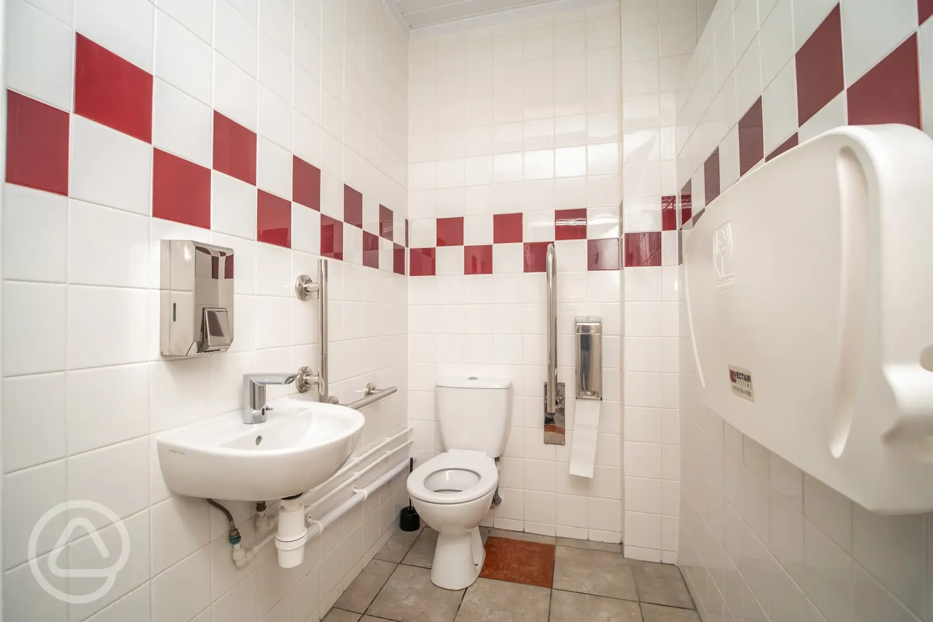 Family/disabled bathroom with a sink and baby changing