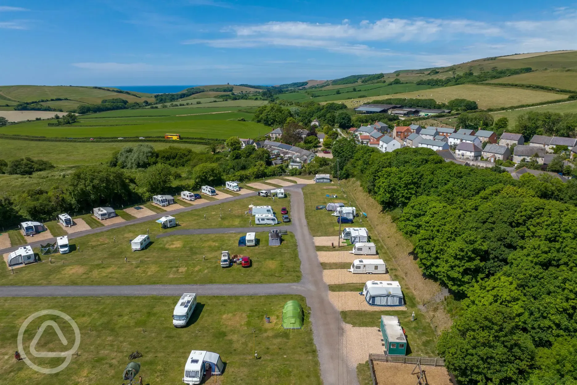 Aerial of Portesham Dairy Farm Campsite with views to Chesil Beach