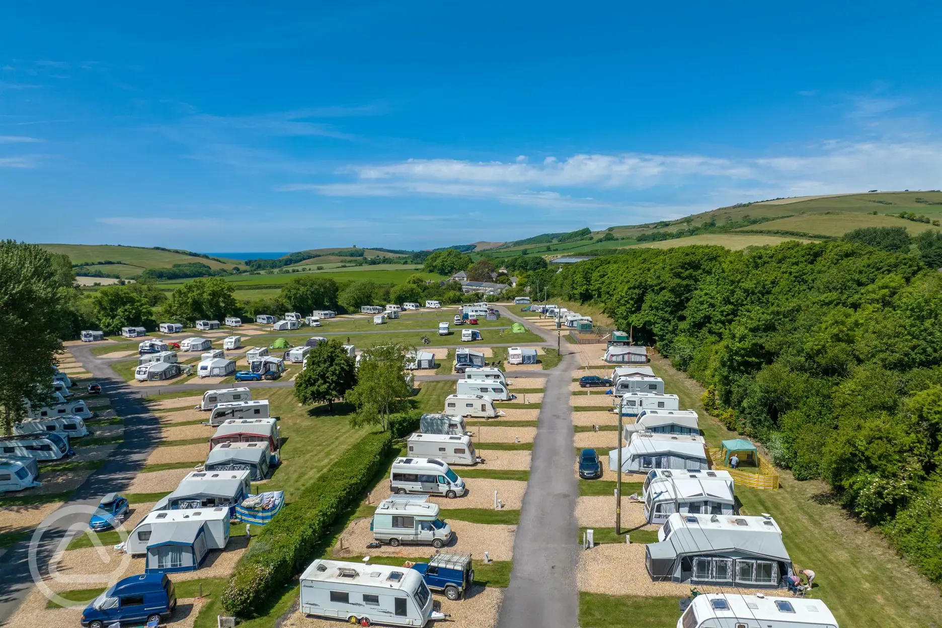 Aerial of Portesham Dairy Farm Campsite with views to Chesil Beach