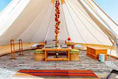 Furnished bell tent with a double bed and bedding