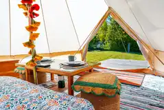 Furnished bell tent with a double bed and bedding