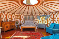 Yurt with a double bed and two fold out single beds