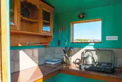 Bell tent private camp kitchen with a camping stove and kettle