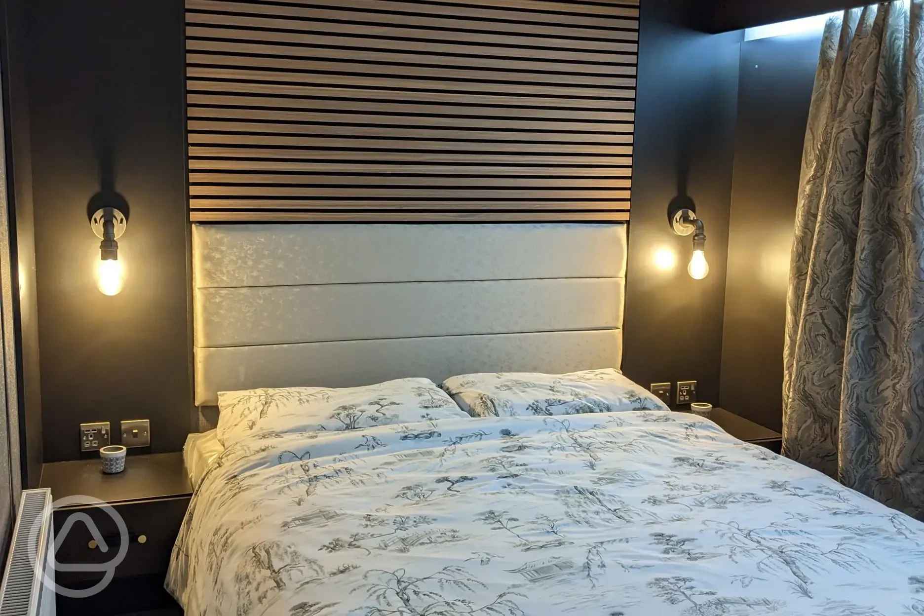 Blencathra camping pod bedroom with king size bed and radiator