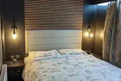 Blencathra camping pod bedroom with king size bed and radiator