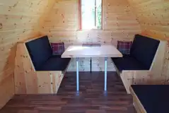 Camping pod dining area that coverts to a bed