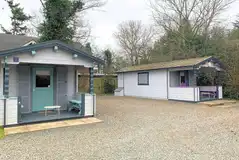 Glamping bothy cabin exterior with shared facilities nearby