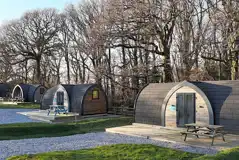 Orchard pods with small decking areas and picnic benches Orchard pods with small decking areas and picnic benches