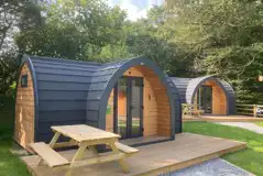 Orchard pods with small decking areas and picnic benches Orchard pods with small decking areas and picnic benches