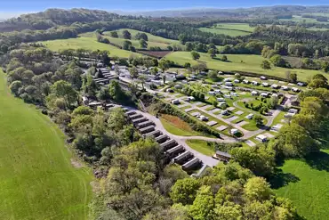 Aerial of Castle Brake Holiday Park surrounded by countryside and woodland
