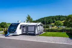 Caravan and awning an a short stay electric hardstanding pitch (8m)