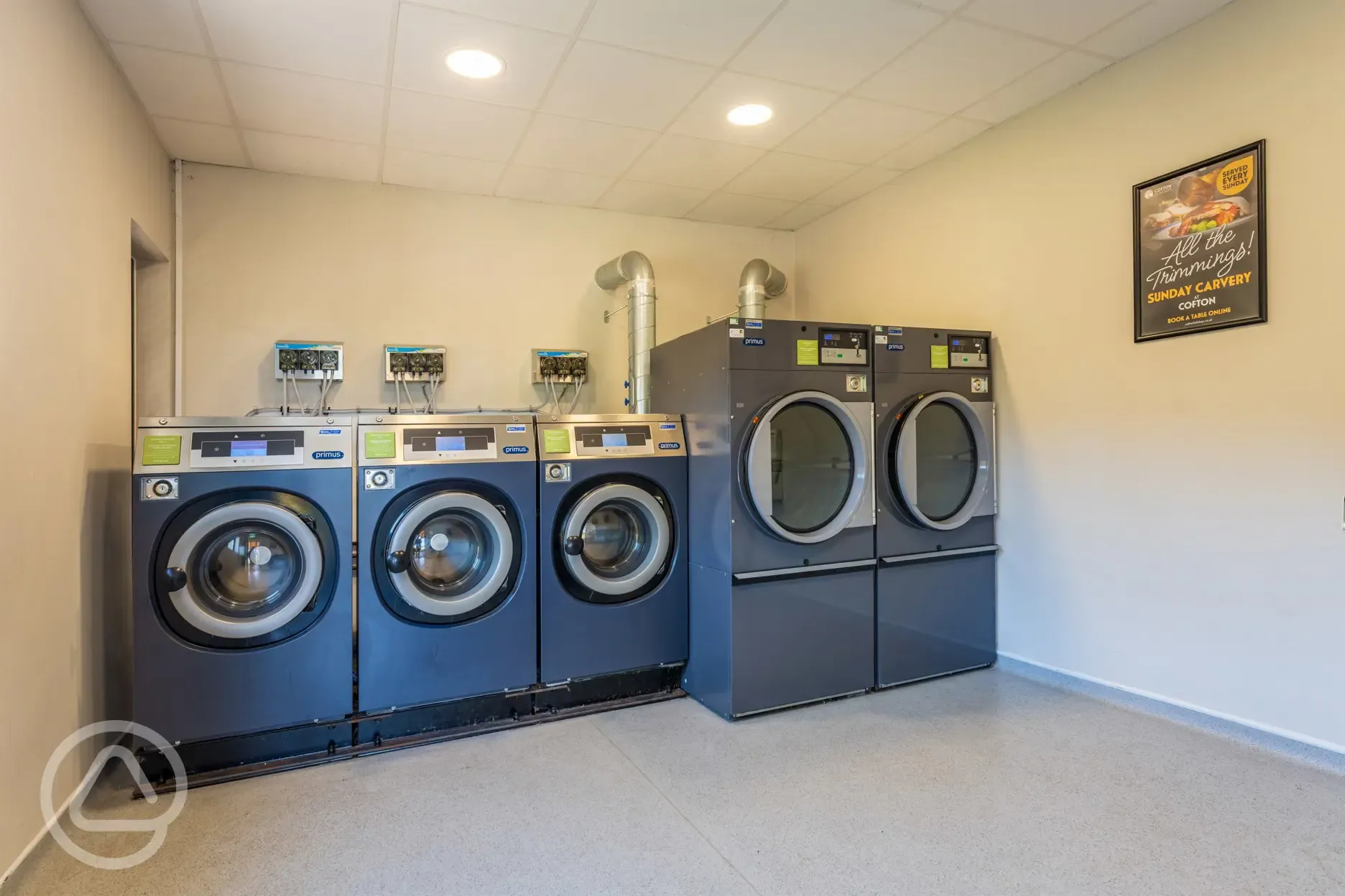 Laundry room with pay-per-use washing machines and tumble dryers