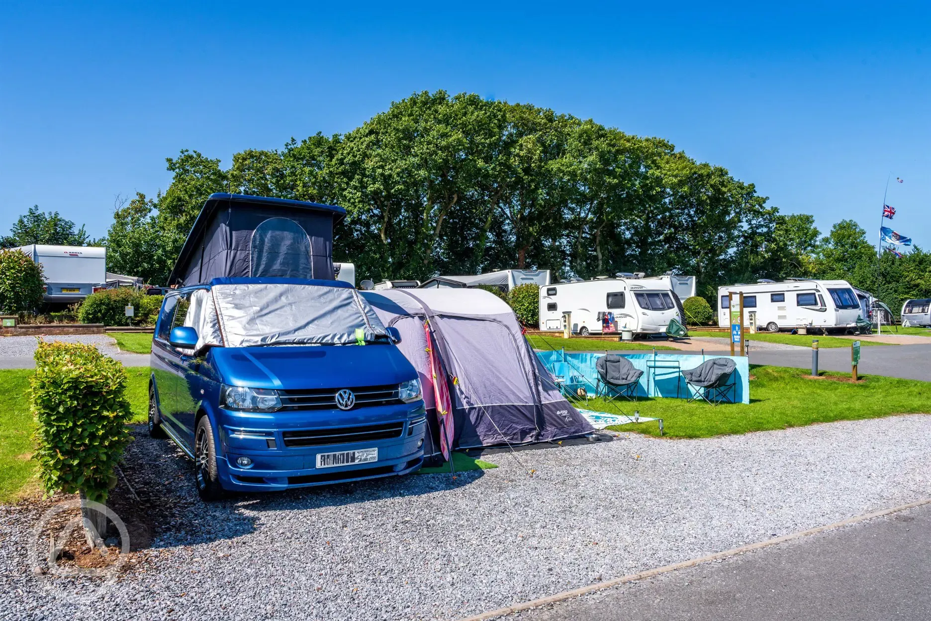 VW campervan and awning on electric hardstanding pitch (6m)