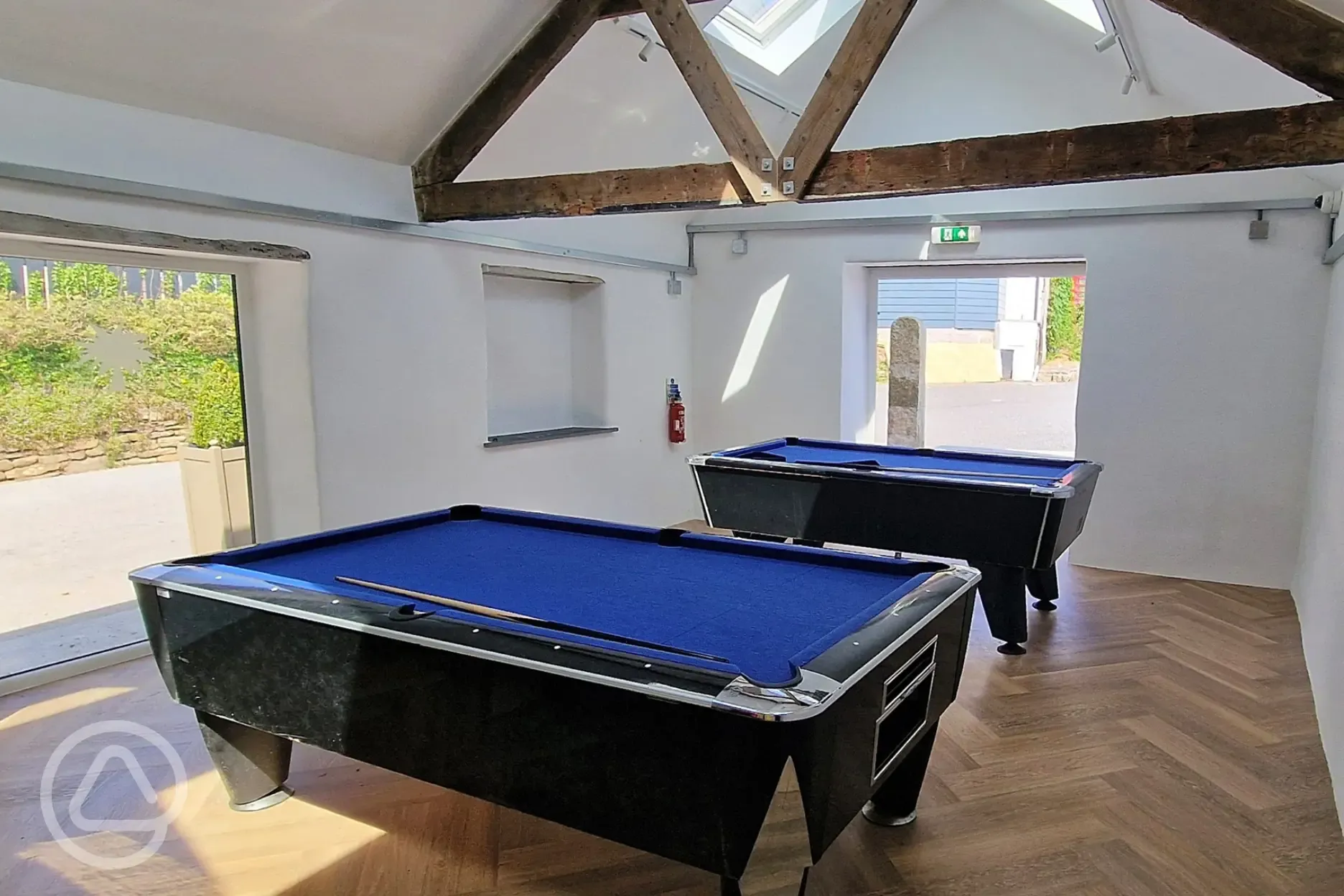 Games room in the Piggery with two pool tables and an air hockey table