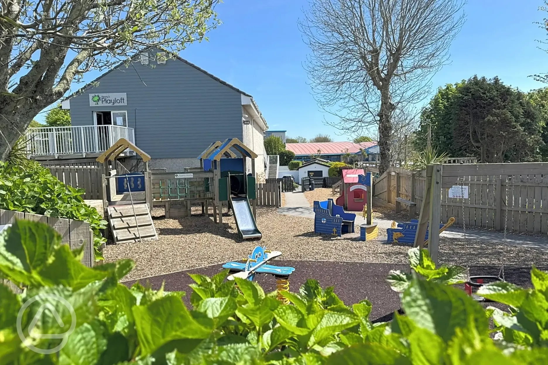 Children's play area with swings, slide and climbing frame