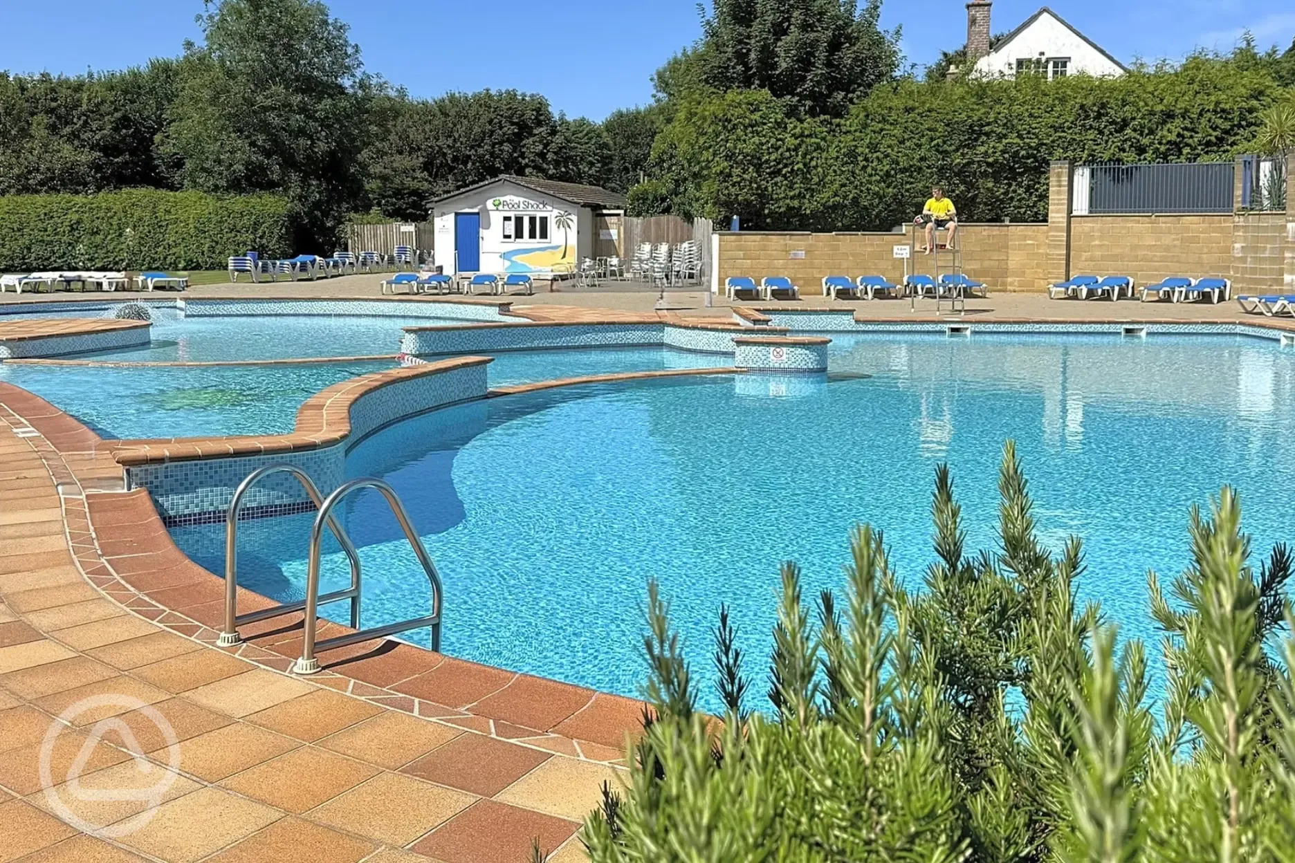 Outdoor swimming pool with deck chairs