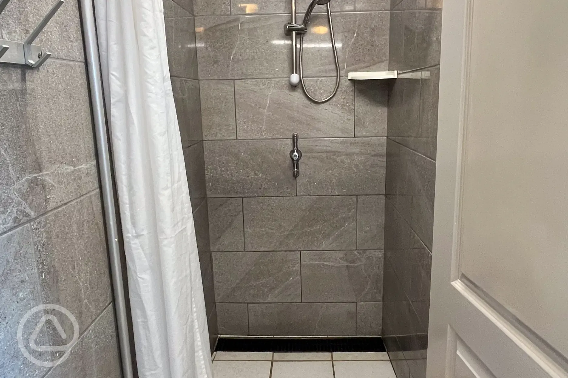 Shower with bottle holder and clothing hooks