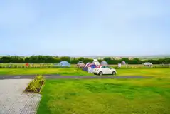 Non electric grass tent pitches with parking beside pitch permitted