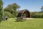 Log pod exterior in Meadow field with private picnic bench and BBQ
