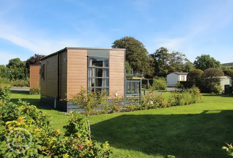 Escape pods with outdoor decks and grass surroundings