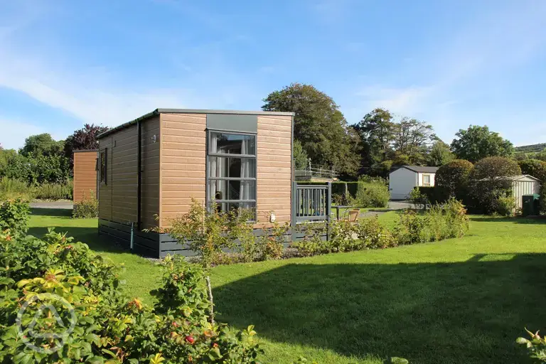 Escape pods with outdoor decks and grass surroundings