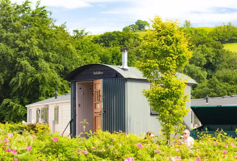 Shepherd's hut in a hedged area of the park
