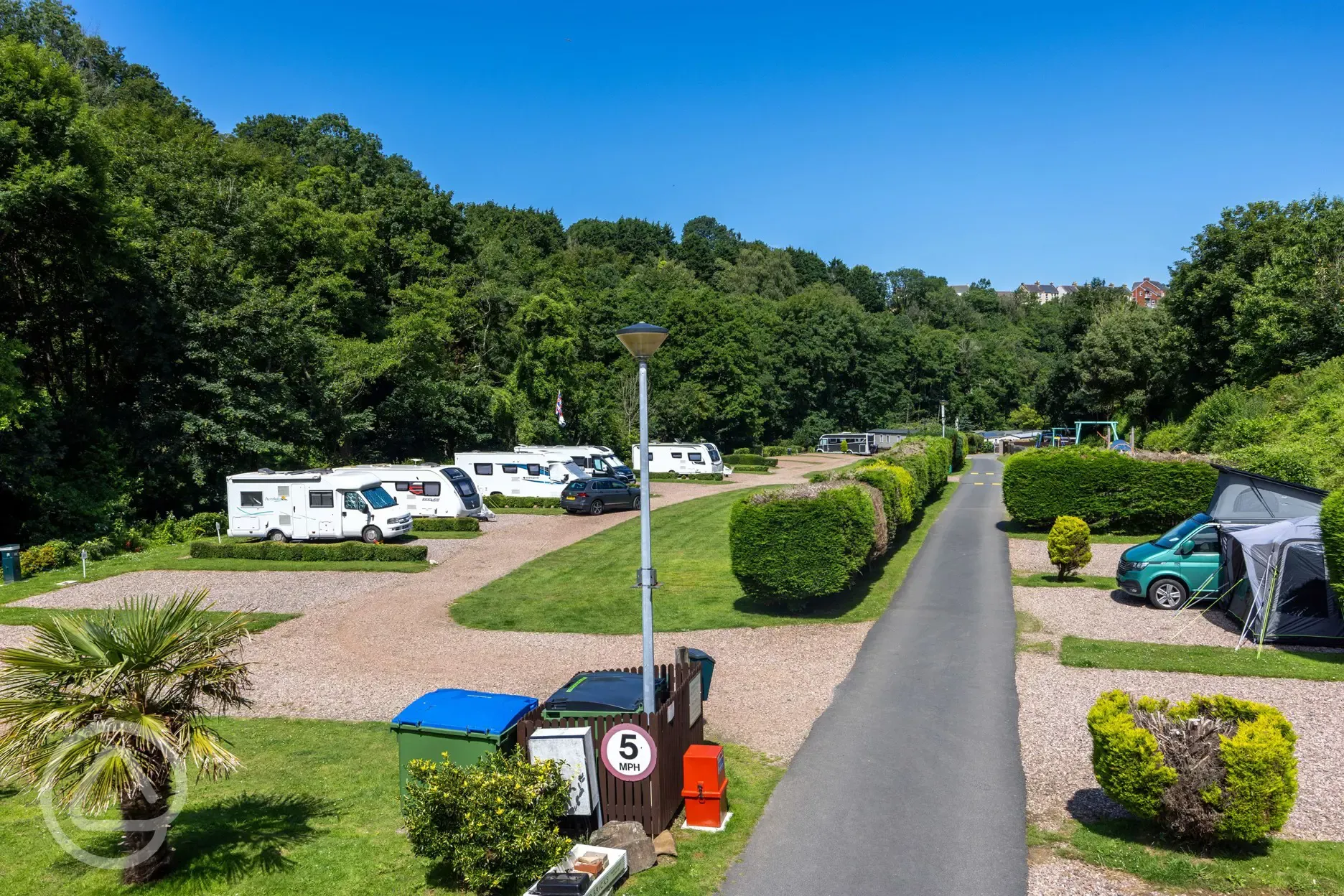 Hardstanding pitches, some with privacy hedging 