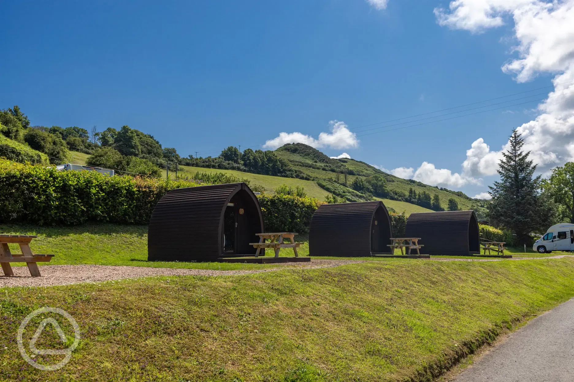 Camping pods with a countryside backdrop